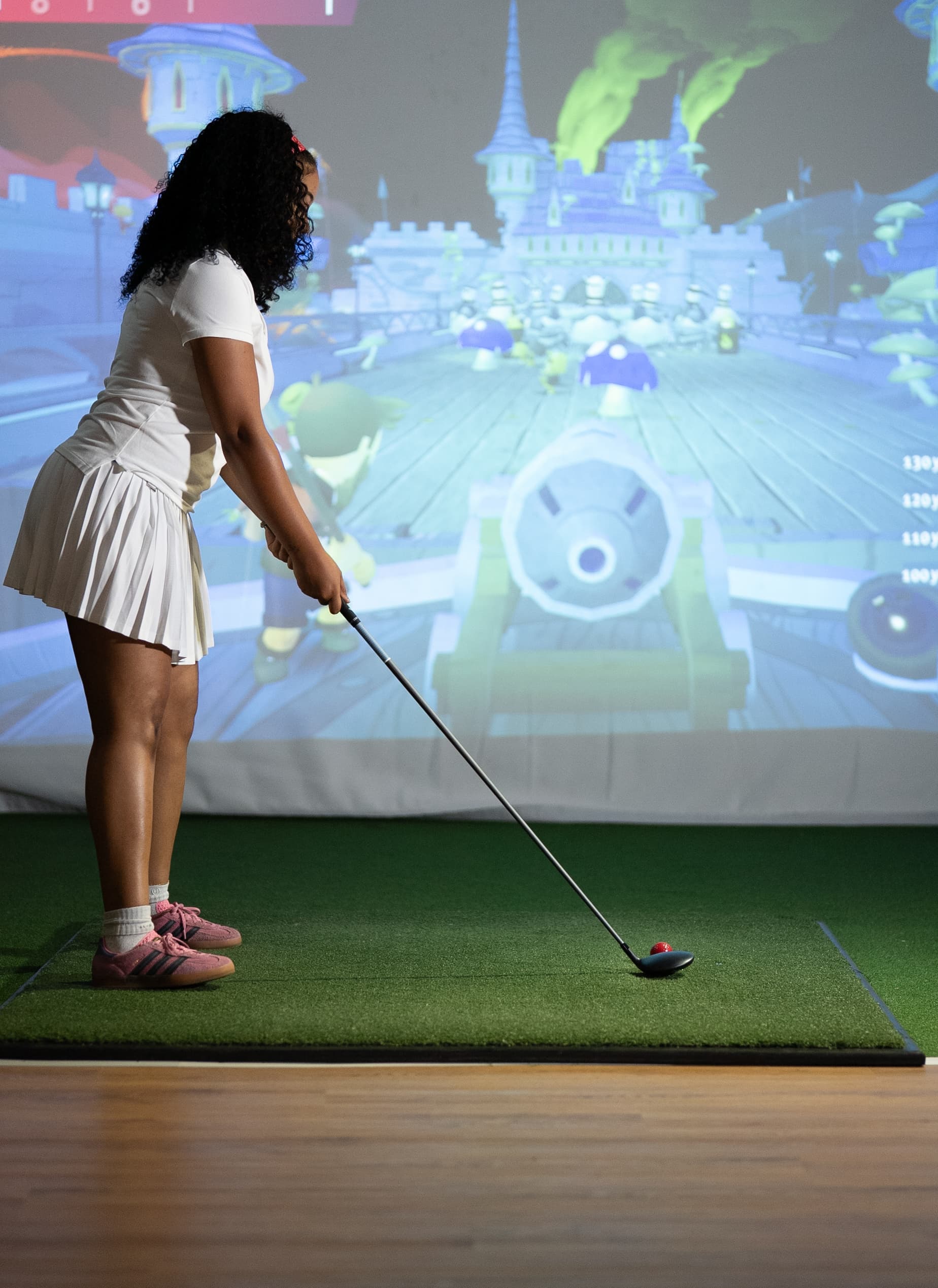 Real golfers playing inside Enzo Golf TrackMan iO simulator bay in Guildford