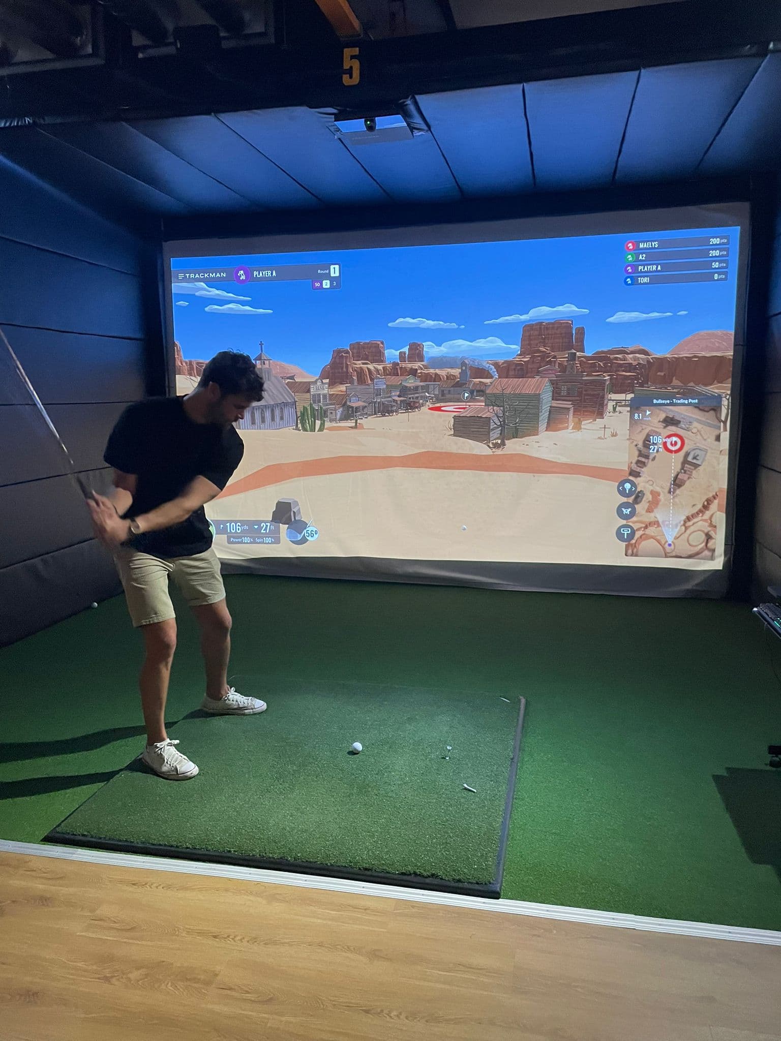 Golfer addressing ball in TrackMan iO bay