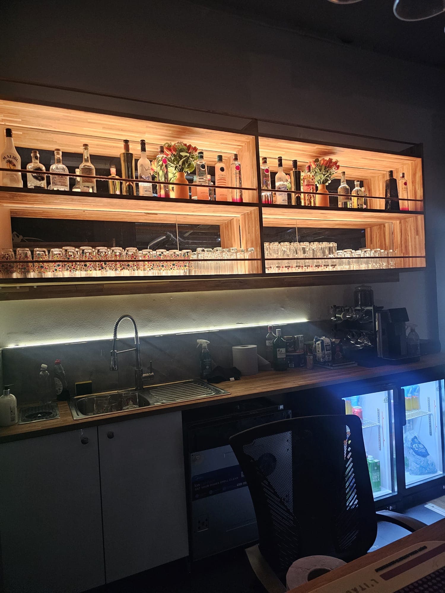 Enzo Golf Guildford illuminated spirit shelves and barista station